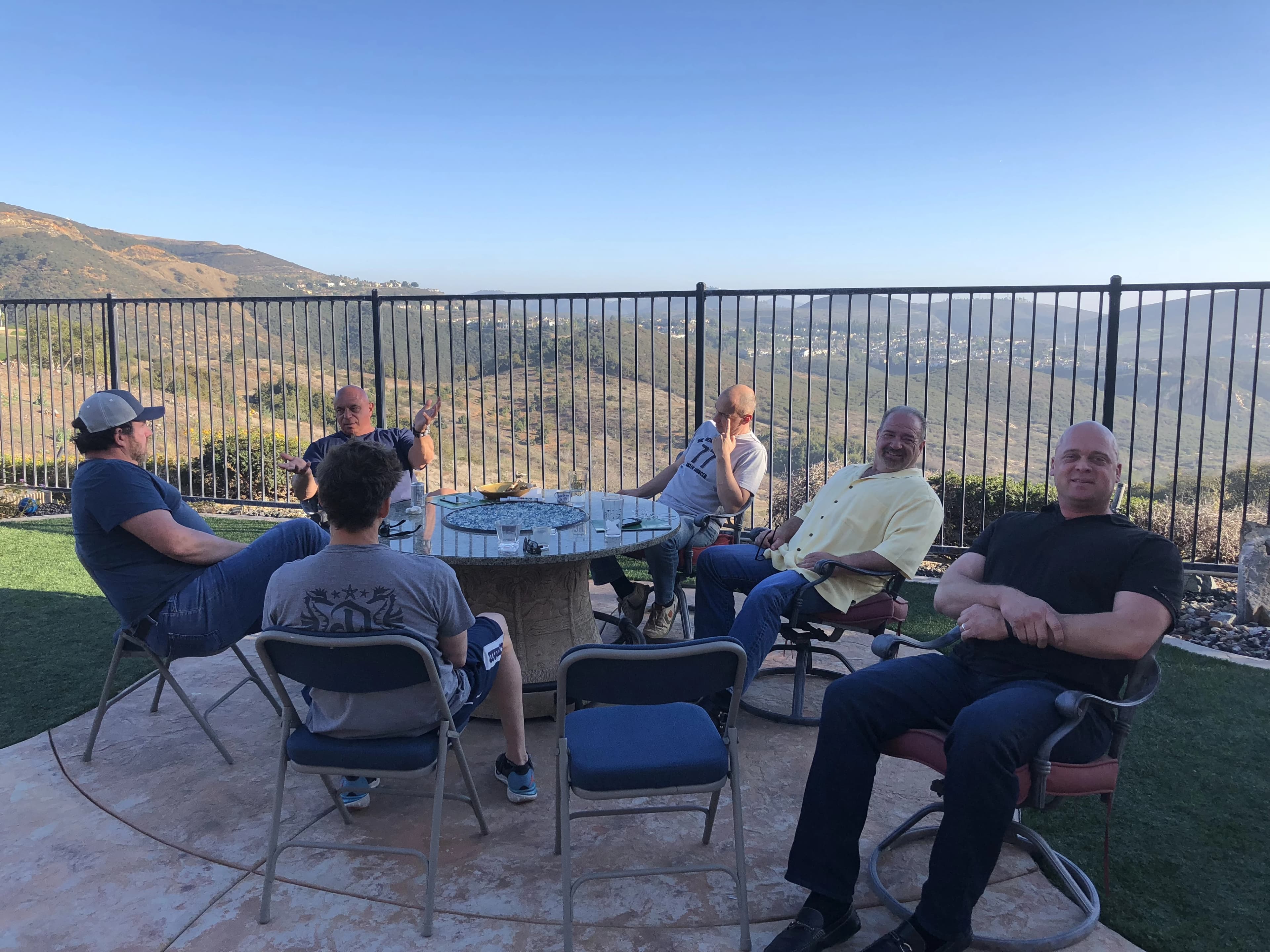 A thoughtful discussion among colleagues overlooking the landscape