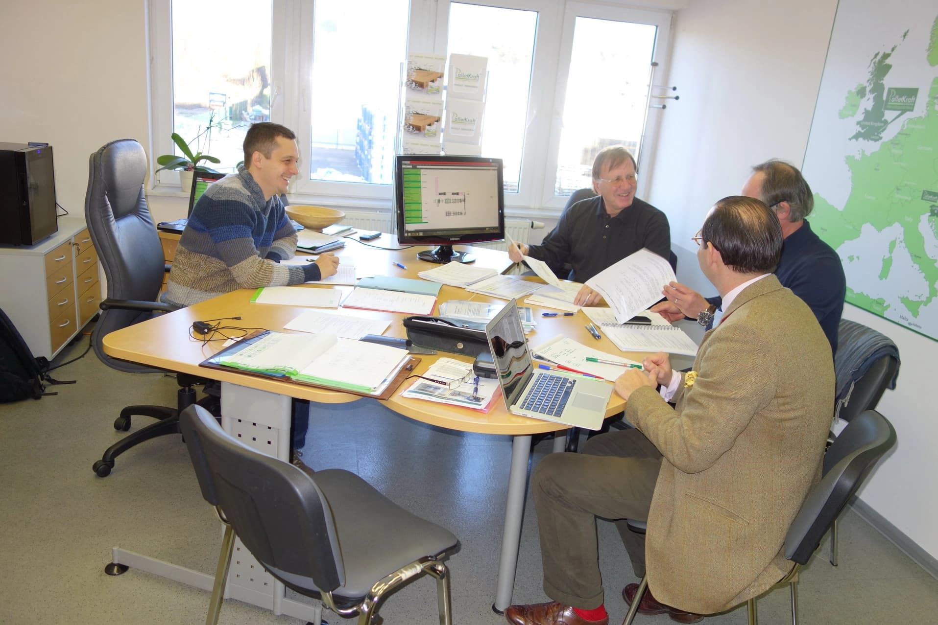 Team members collaborating around a meeting table