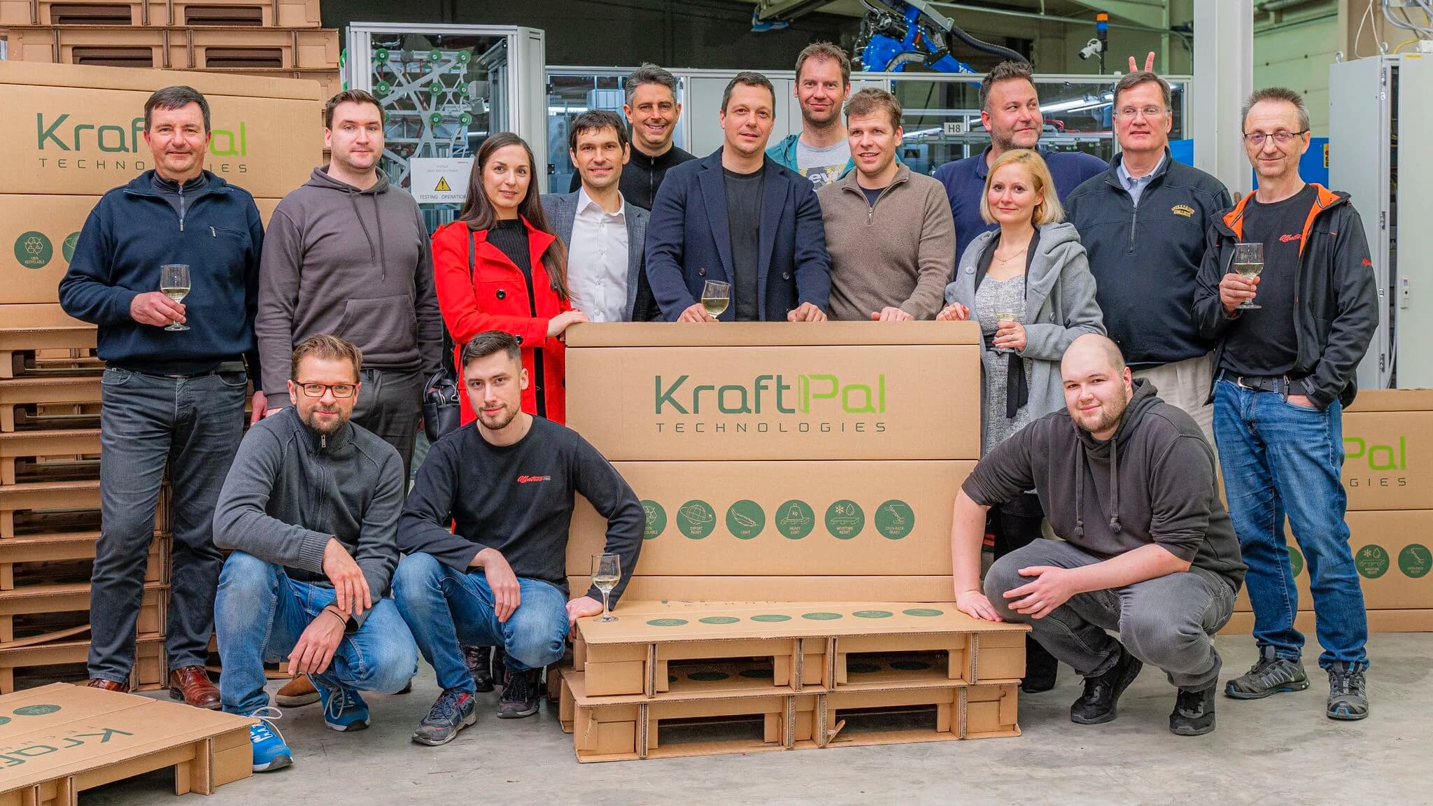 KraftPal manufacturing team gathered around a fibre pallet