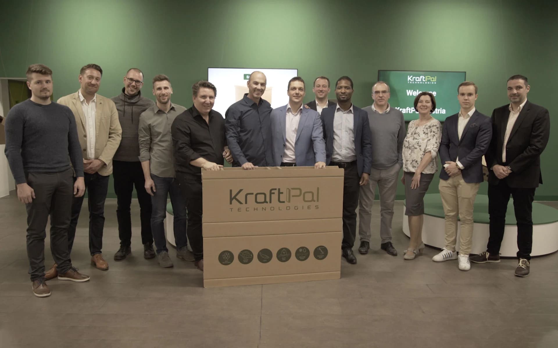 KraftPal team members standing together with a KraftPal pallet