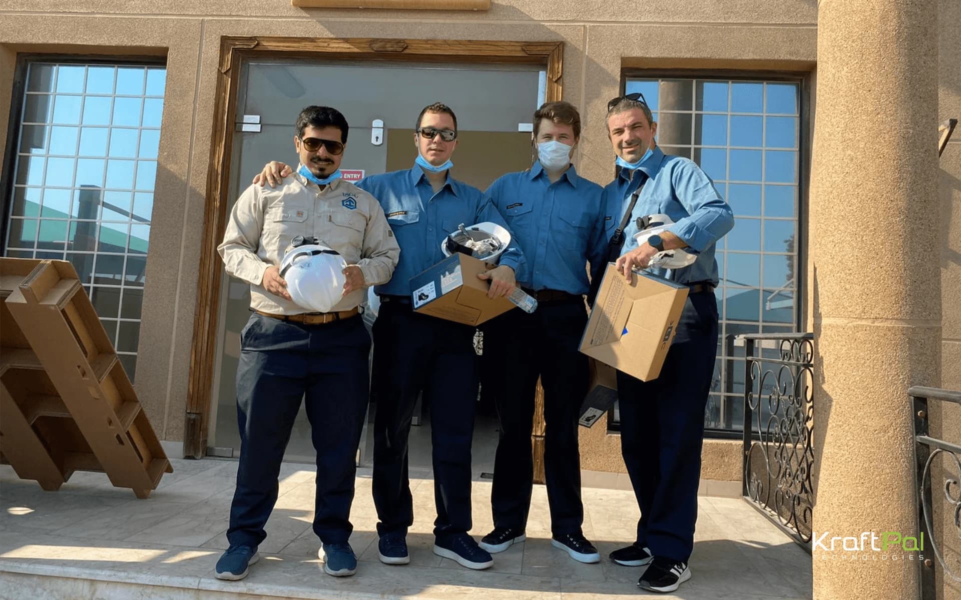 KraftPal team members holding awards outside a building