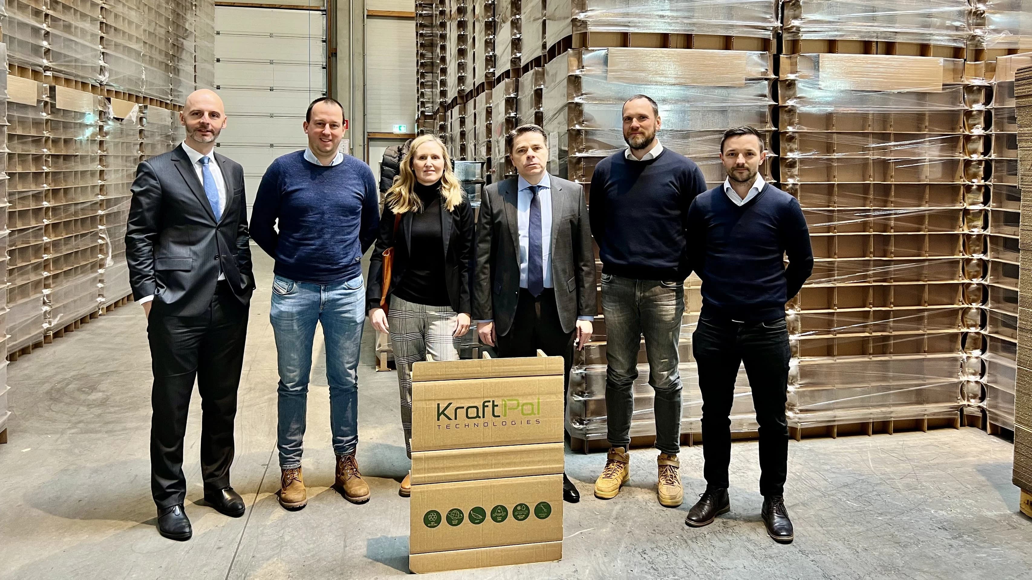 KraftPal team standing in a warehouse with a finished KraftPal pallet