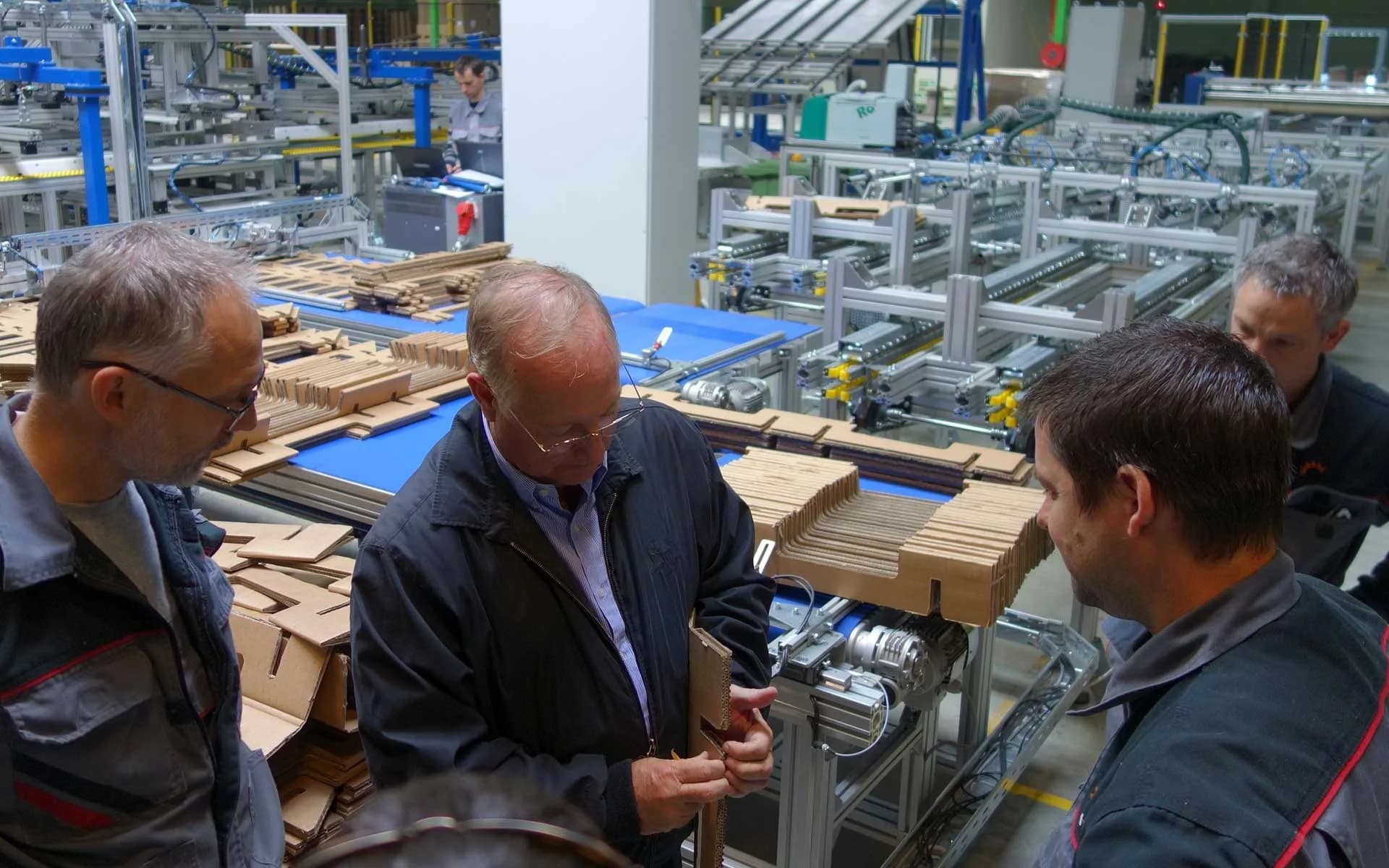 KraftPal engineering team gathered around a fibre pallet