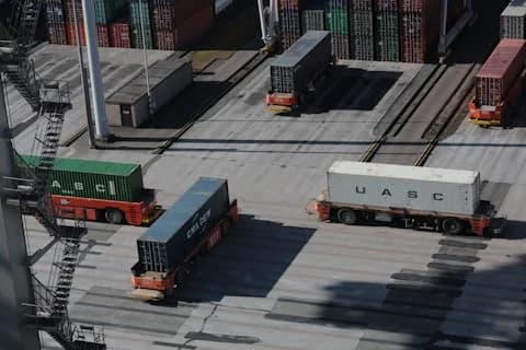 Freight vehicles moving through a logistics terminal