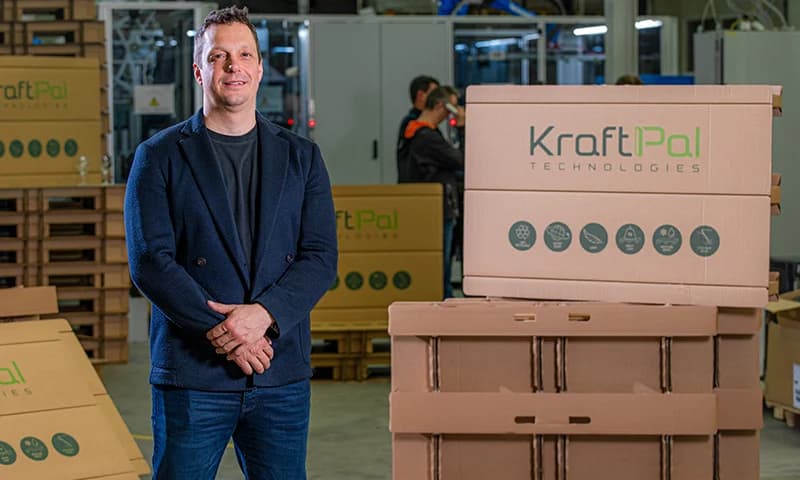 KraftPal founder standing beside finished pallet products